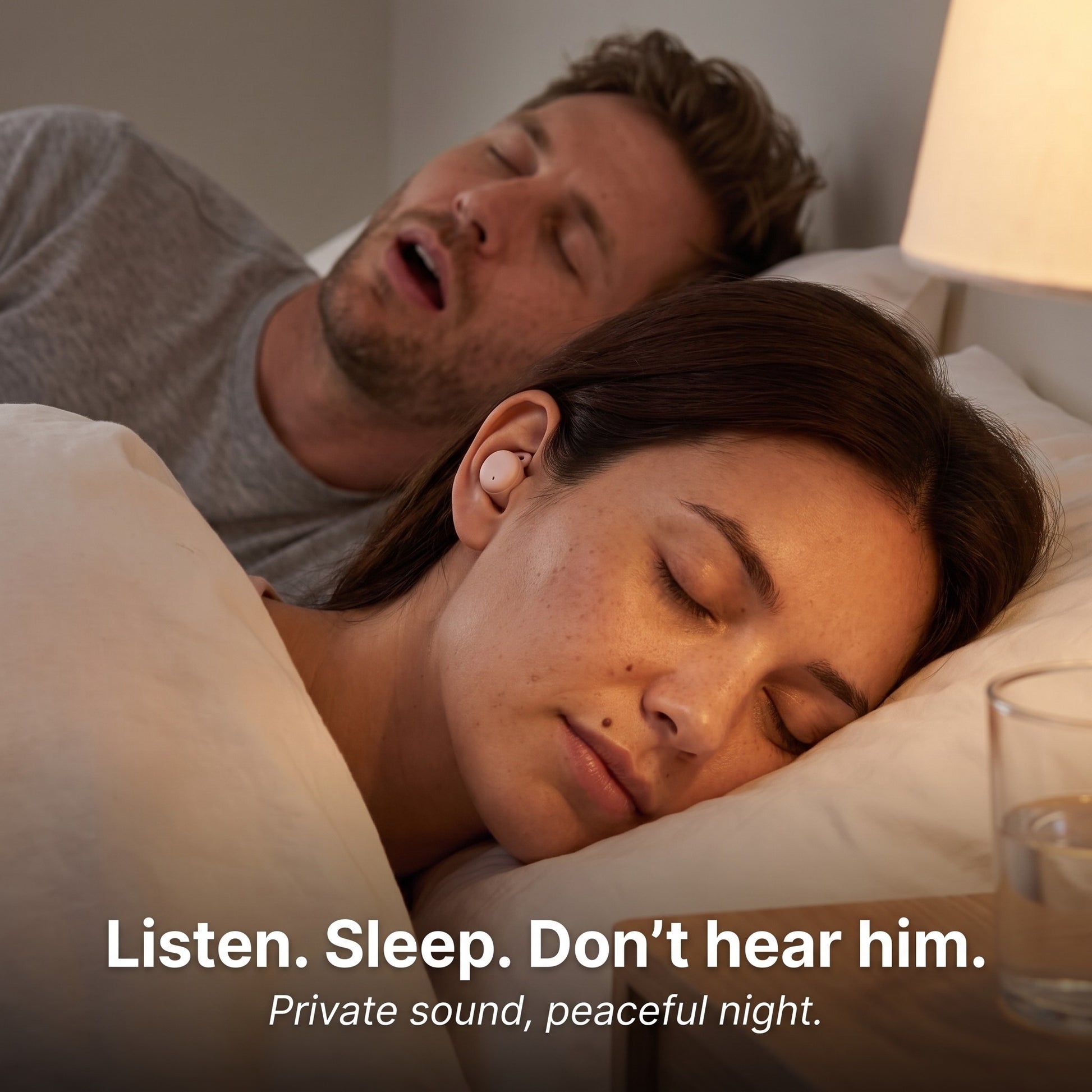 ViSound™ Hush sleep earbuds worn by a woman in bed, while a man snores beside her in a softly lit room.